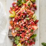 Platter full of roast salmon with strawberry jalapeno salsa.