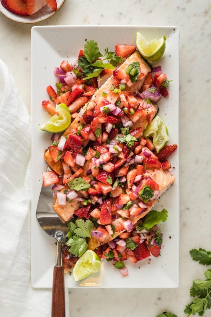 Platter full of roast salmon with strawberry jalapeno salsa.