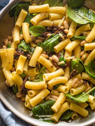Skillet filled with a Tuscan-inspired pasta with Cannellini beans.