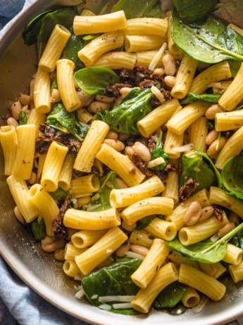 Skillet filled with a Tuscan-inspired pasta with Cannellini beans.