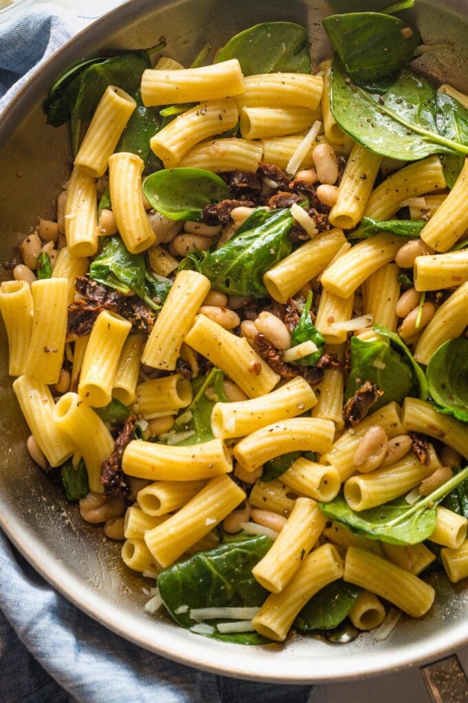 Skillet filled with a Tuscan-inspired pasta with Cannellini beans.