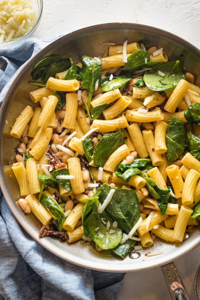 Skillet filled with a Tuscan-inspired pasta with Cannellini beans. 