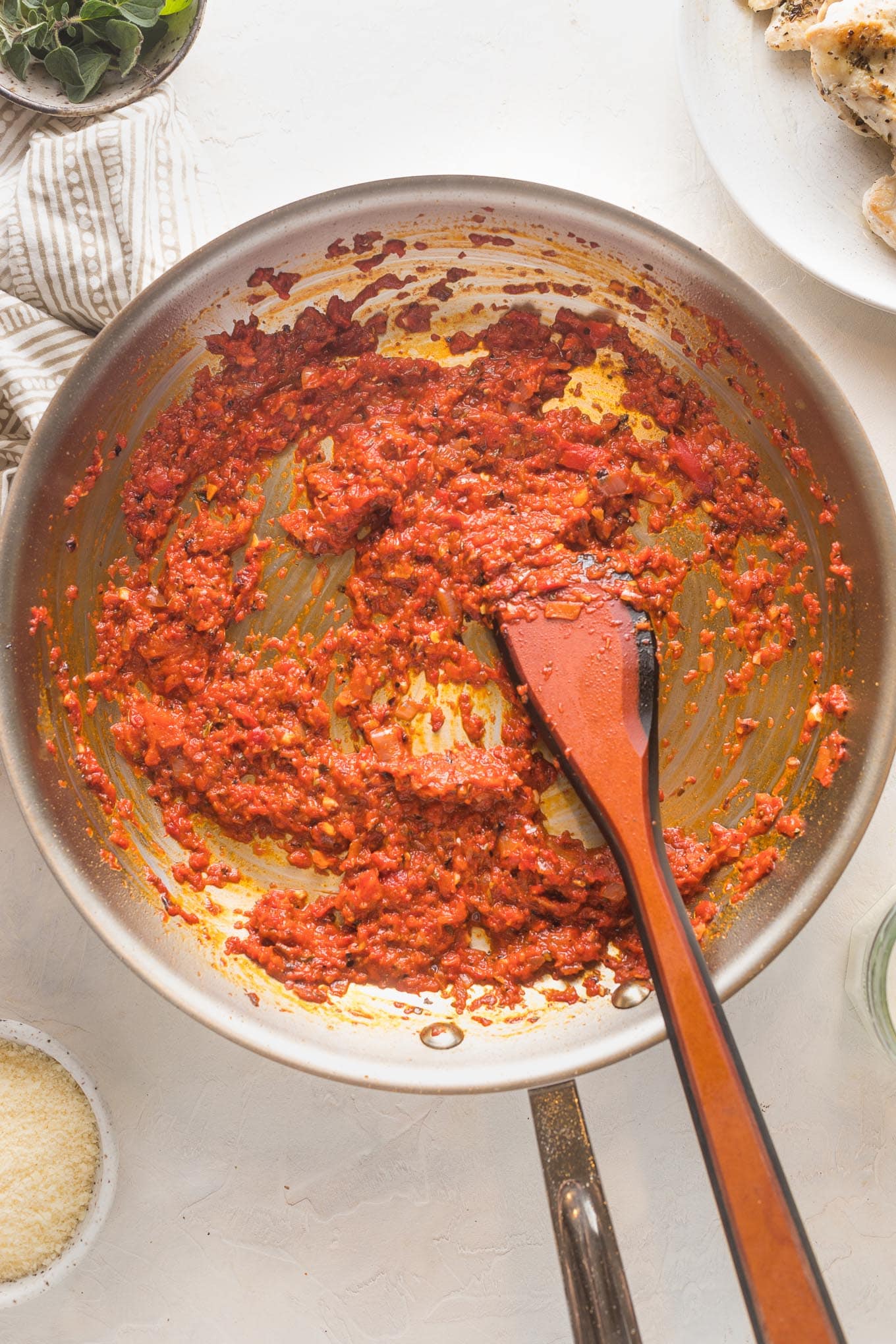 Red pepper sauce simmering with shallots in a medium-large skillet.