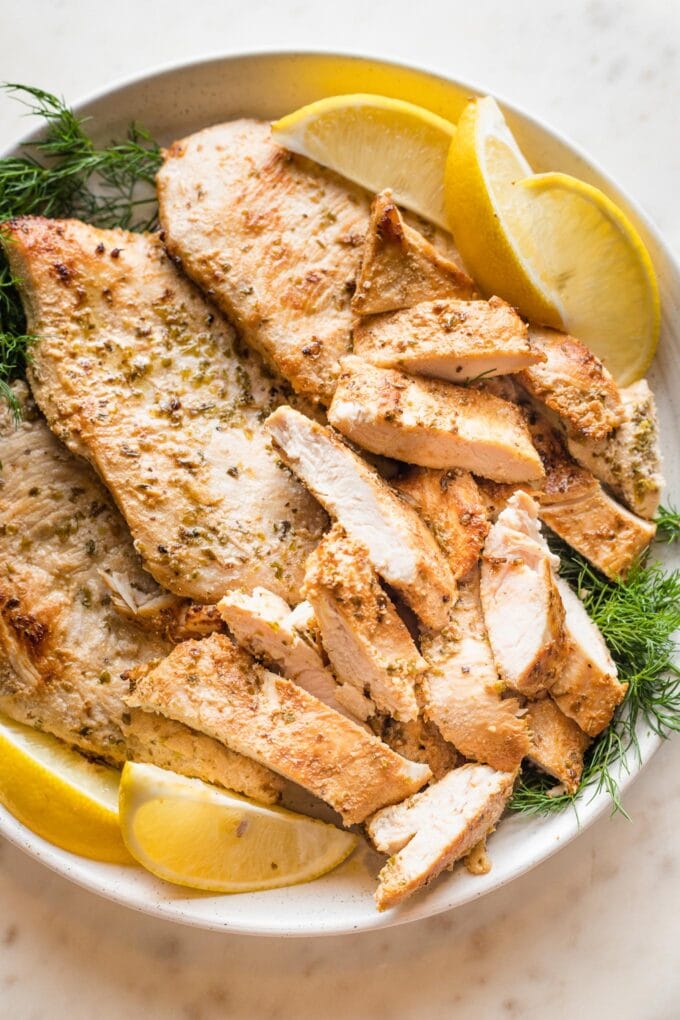 Close-up of a sliced Greek-marinated chicken breast.