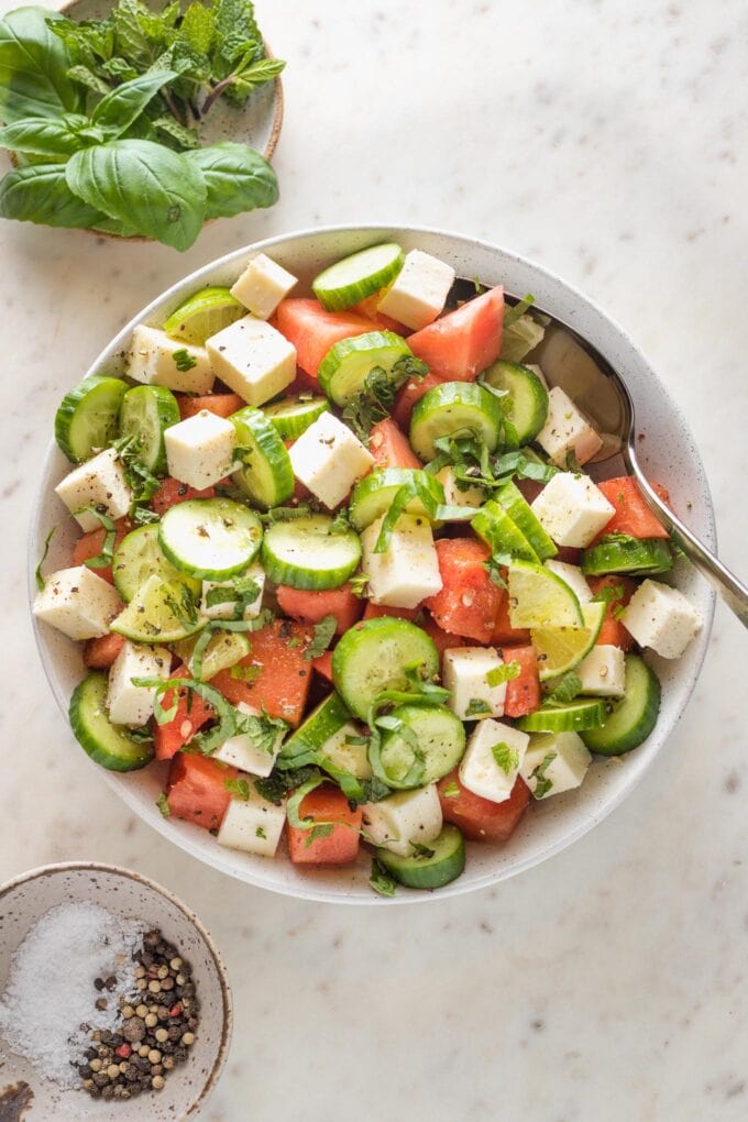 Bowl full of watermelon cucumber salad with feta and mint.