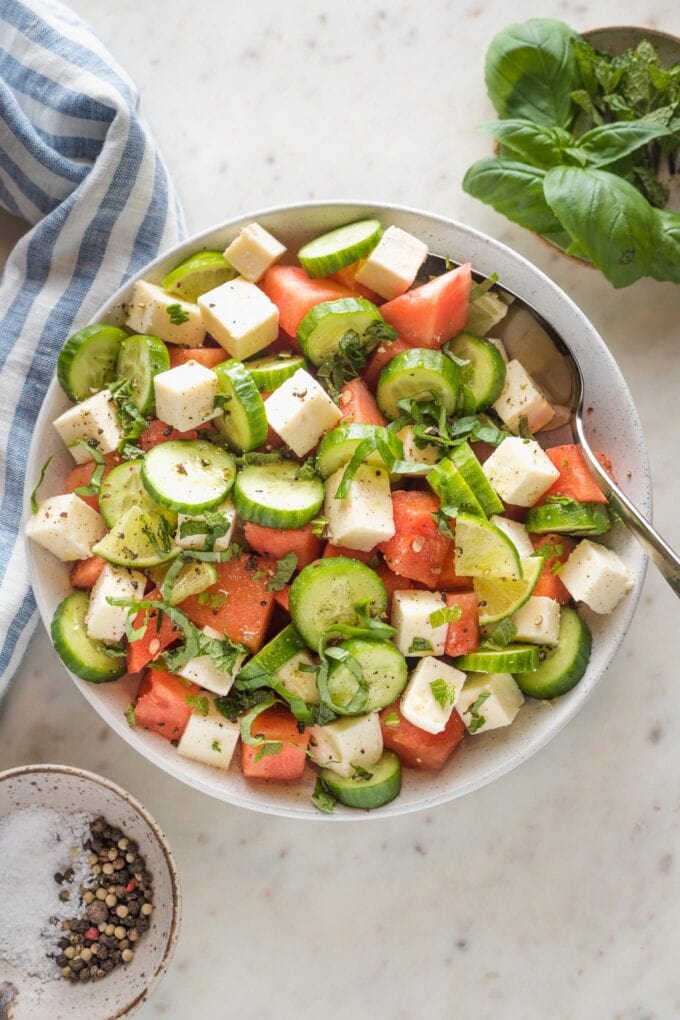 Bowl full of watermelon cucumber salad with feta and mint.