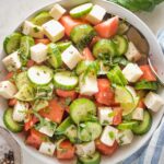 Bowl full of watermelon cucumber salad with feta and mint.