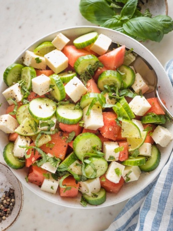 Bowl full of watermelon cucumber salad with feta and mint.