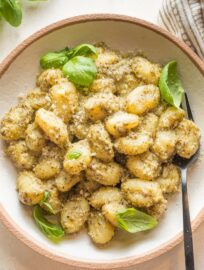 This Creamy Pesto Gnocchi is a comforting, family-friendly vegetarian meal that takes just 20 minutes from start to finish. Cook the gnocchi straight in the sauce for a true one pan wonder you'll enjoy time and again.