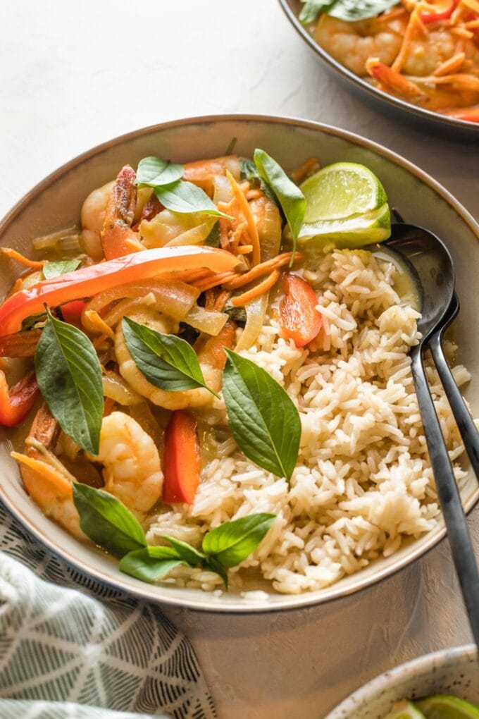 Bowl of Thai green curry with veggies and shrimp served over rice.