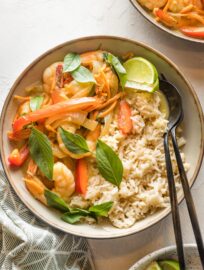 Bowl of Thai green curry with veggies and shrimp served over rice.