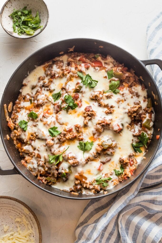 Large cast iron pan filled with a stuffed pepper skillet.
