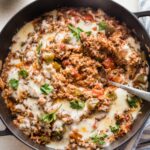 Large cast iron pan filled with a stuffed pepper skillet.