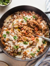 Large cast iron pan filled with a stuffed pepper skillet.