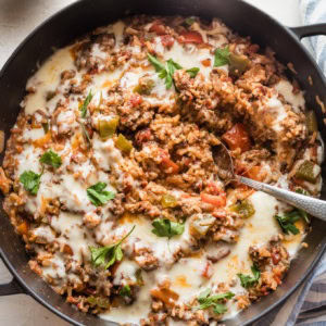Large cast iron pan filled with a stuffed pepper skillet.
