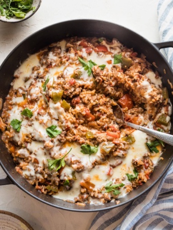 Large cast iron pan filled with a stuffed pepper skillet.