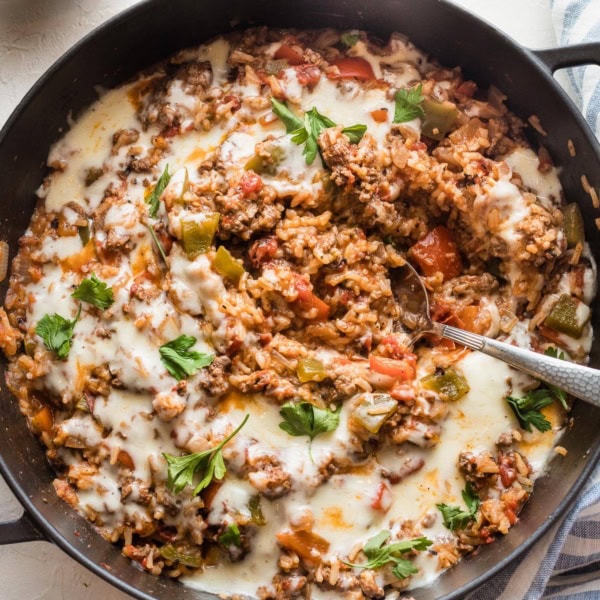 Large cast iron pan filled with a stuffed pepper skillet.