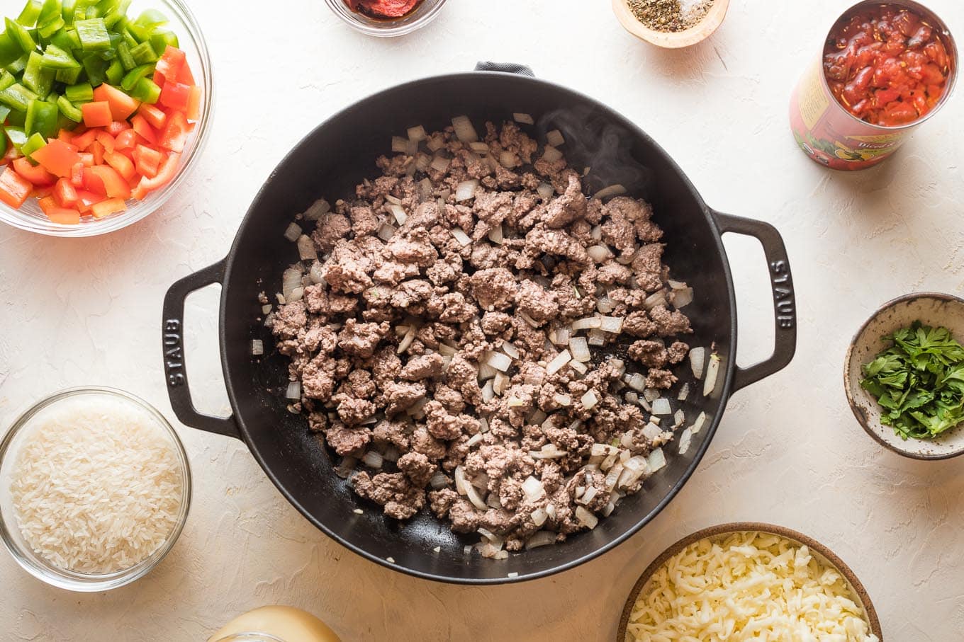 Browned beef, onion, and garlic in a pan.