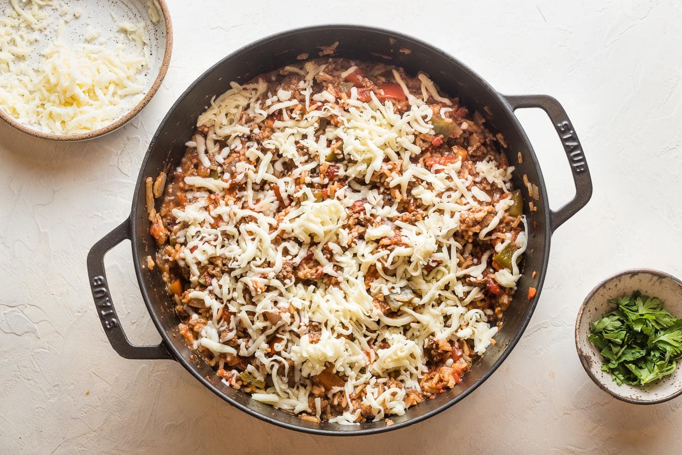 Mozzarella cheese shredded on top of unstuffed pepper mixture.