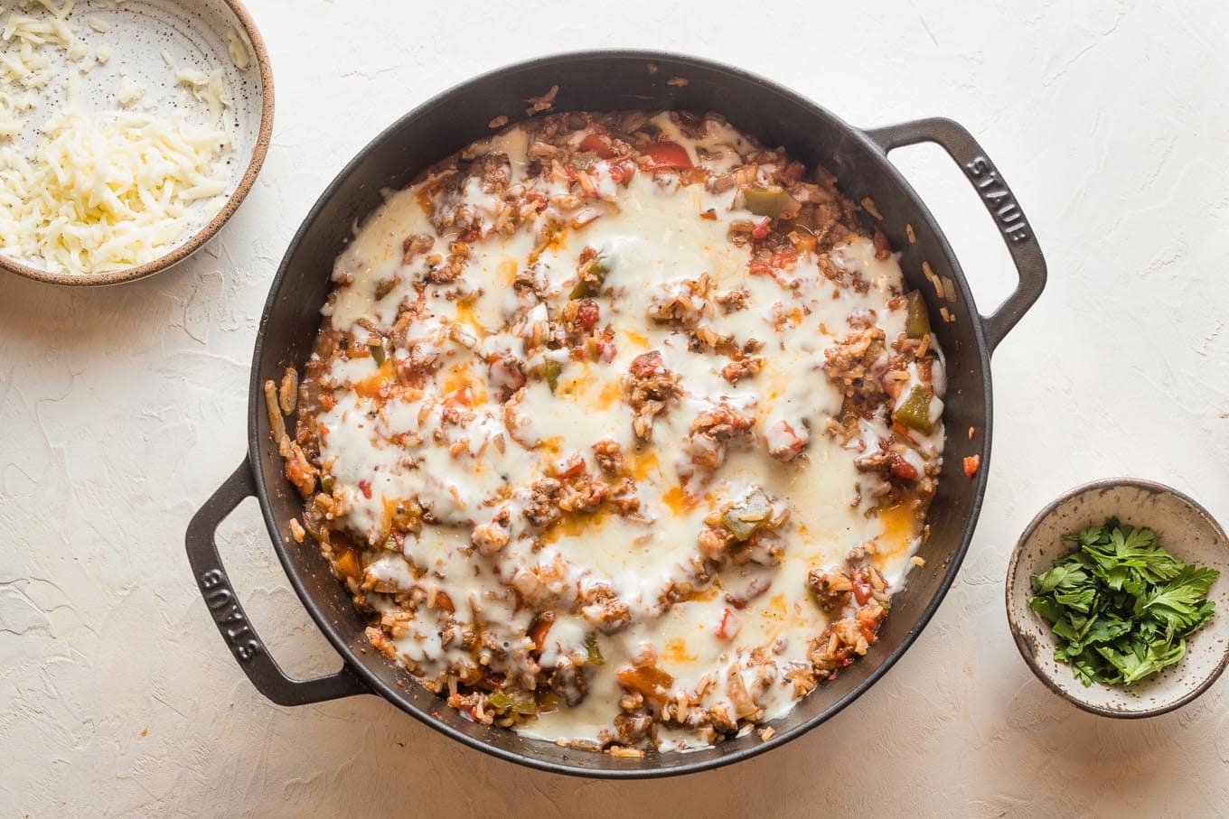 Melted cheese over skillet.