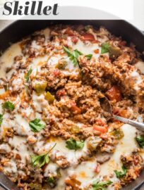 This easy ground beef Stuffed Pepper Skillet has all the cozy flavors of traditional stuffed peppers -- tender rice, healthy veggies, and creamy mozzarella -- but made in one pan in about 30 minutes. Weeknight dinner perfection!