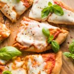 Close-up of a cheesy slice of naan pizza.