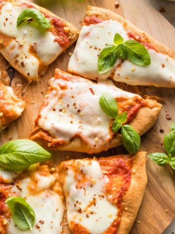 Close-up of a cheesy slice of naan pizza.