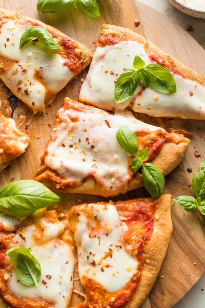 Close-up of a cheesy slice of naan pizza.