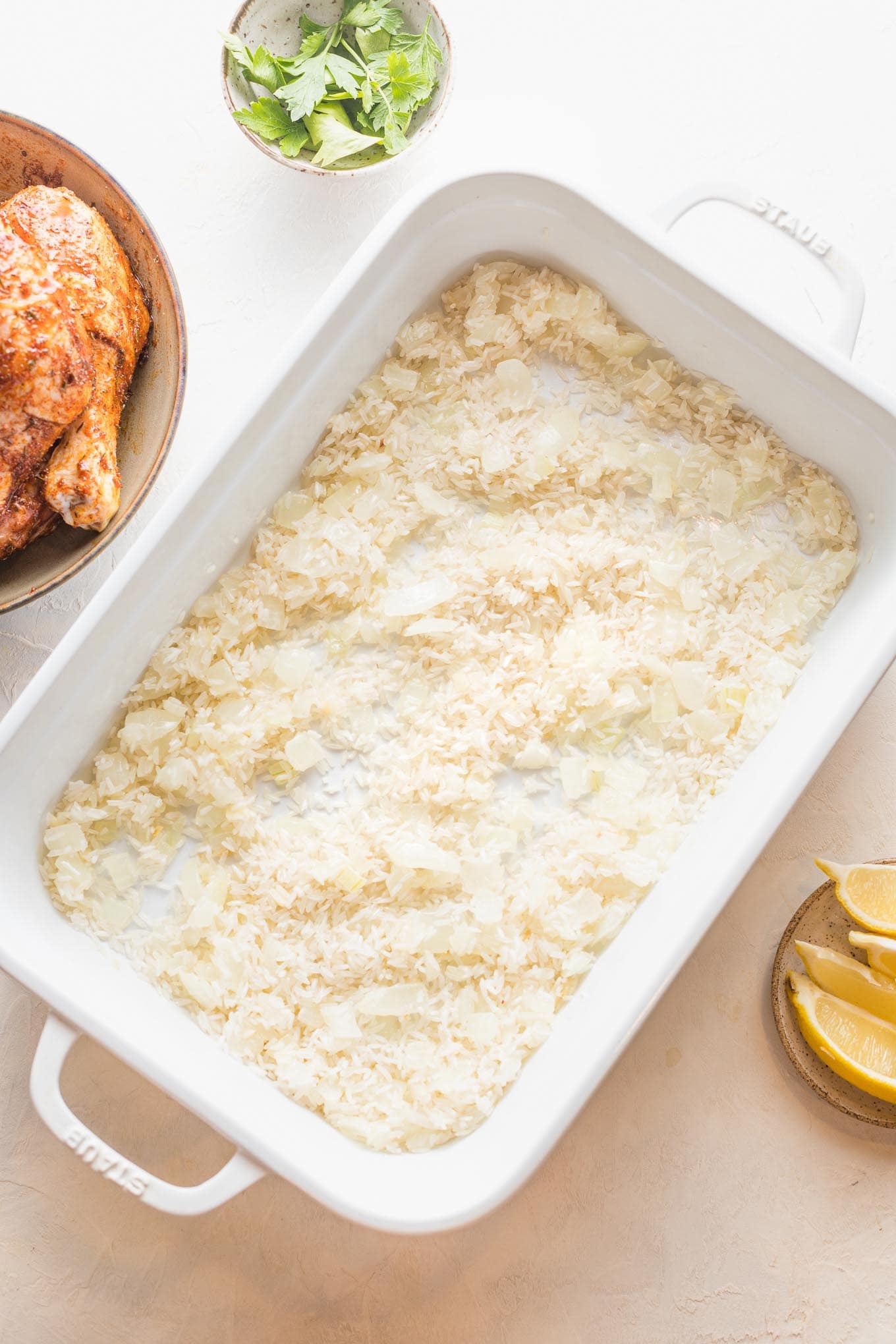 Rice added to onions in pan.