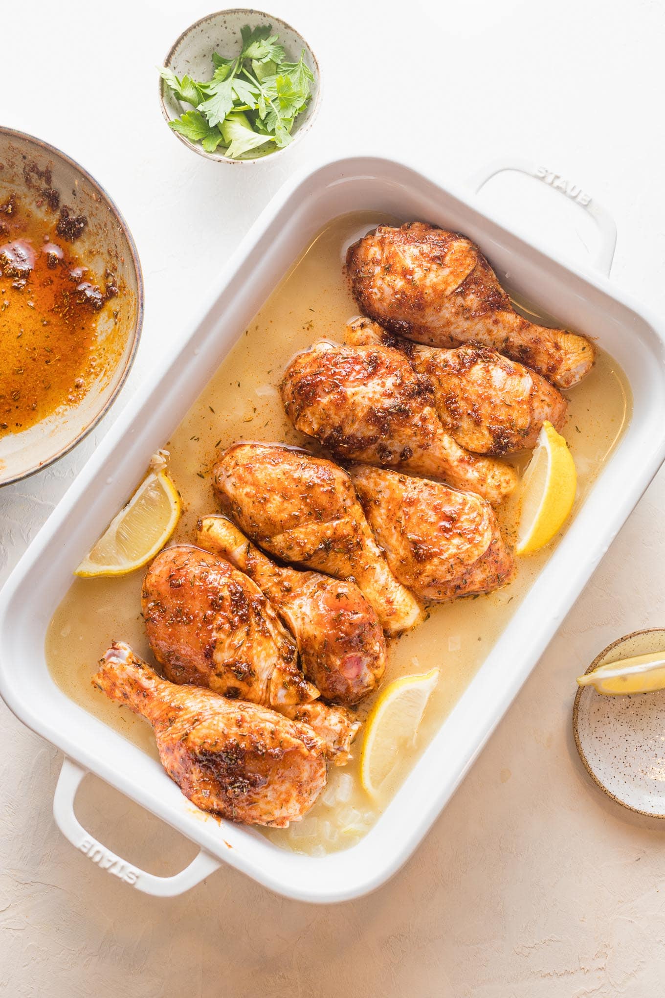 Chicken nestled on top of uncooked rice with water and seasonings.