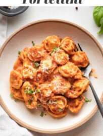 This easy recipe for tortellini with creamy tomato sauce will help you make a delicious, real food dinner in just 15 minutes! The tortellini cook right in the sauce for a true one pan wonder with rich flavor.