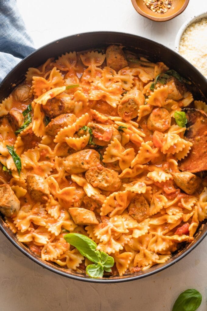 Chicken sausage pasta in a cast iron skillet.