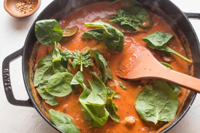 Baby spinach stirred into skillet.