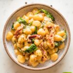 Pasta bowl with a serving of Tuscan gnocchi in a cream sauce.