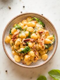 Pasta bowl with a serving of Tuscan gnocchi in a cream sauce.