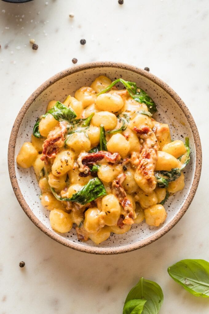 Pasta bowl with a serving of Tuscan gnocchi in a cream sauce.