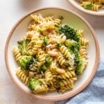 Small pasta bowl with a serving of pasta with white beans and broccoli.