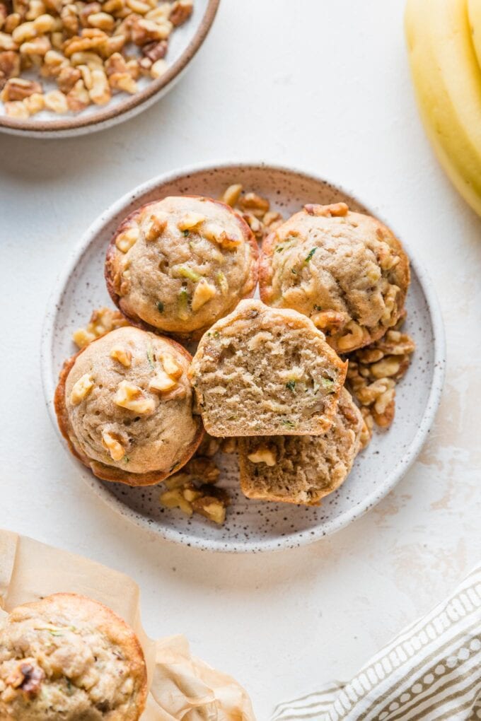 Banana zucchini muffin cut open to reveal the soft texture inside.