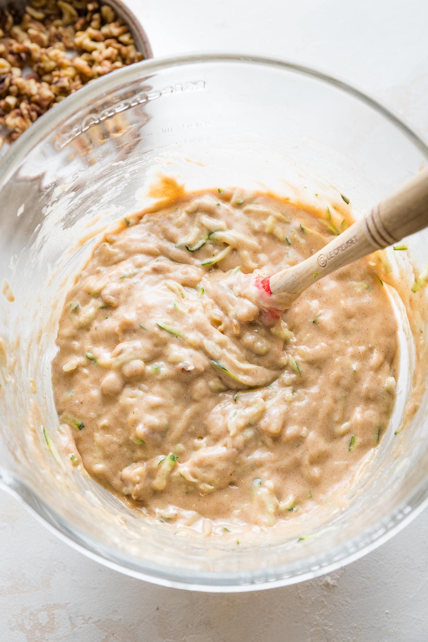 Muffin batter with zucchini and walnuts gently folded in.