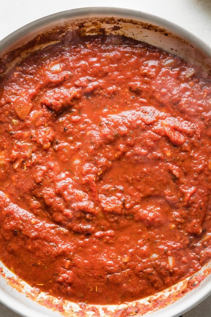 Close up of a rich homemade tomato sauce in a skillet.