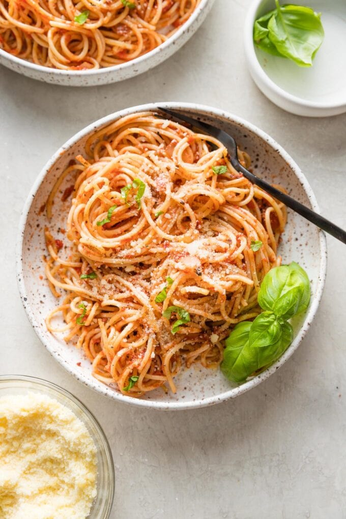 Small bowl filled with a large serving of pasta Napoletana.