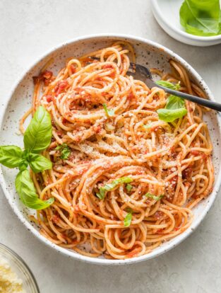 Small bowl filled with a large serving of pasta Napoletana.