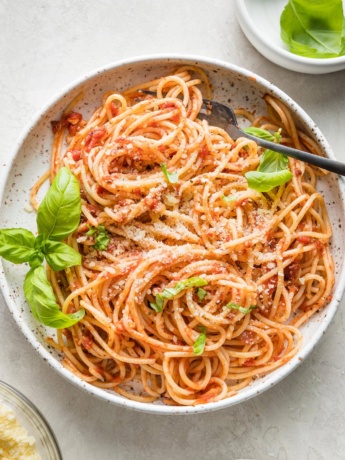 Small bowl filled with a large serving of pasta Napoletana.