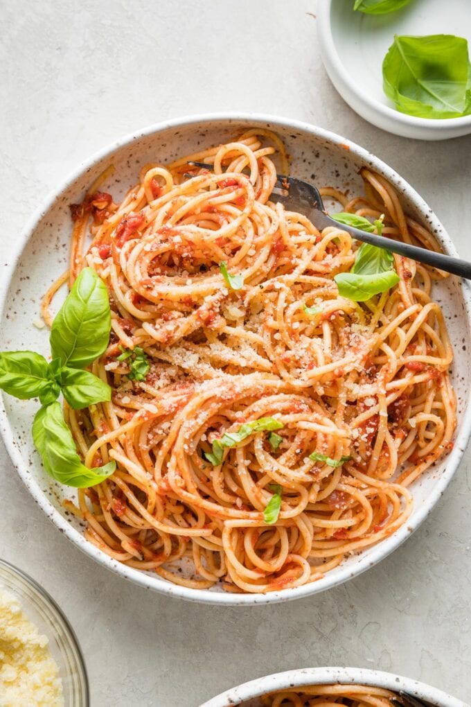Small bowl filled with a large serving of pasta Napoletana.