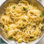 Close-up of a skillet of lemon caper pasta.