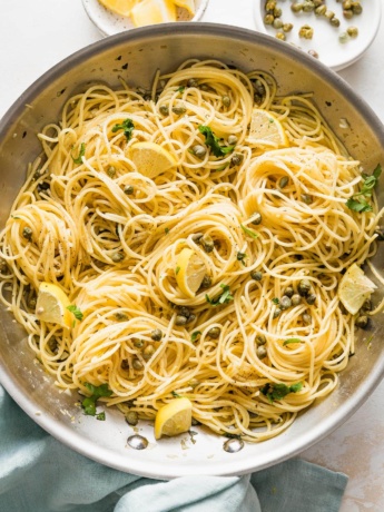 Close-up of a skillet of lemon caper pasta.