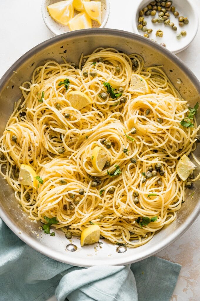 Close-up of a skillet of lemon caper pasta.