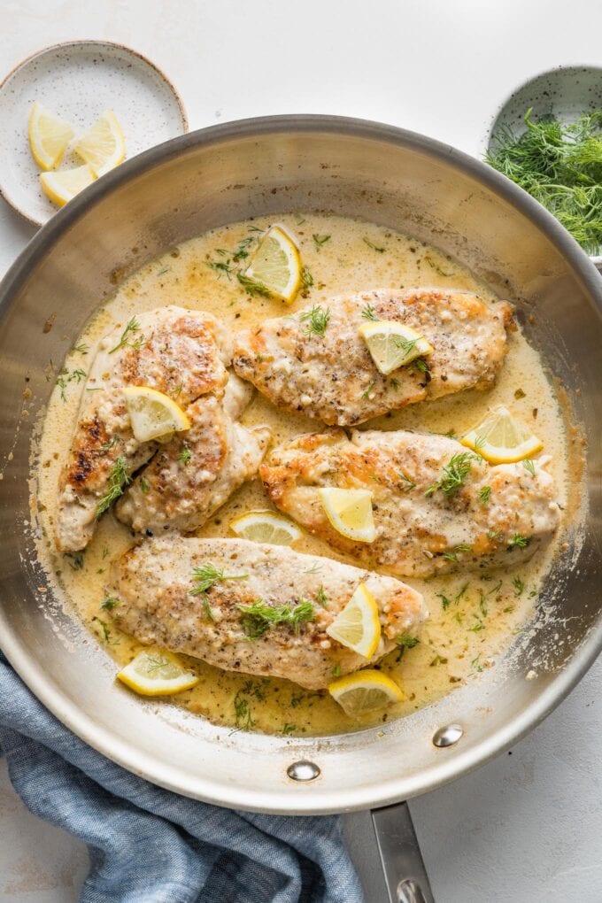 Overhead image of a skillet filled with creamy lemon chicken.