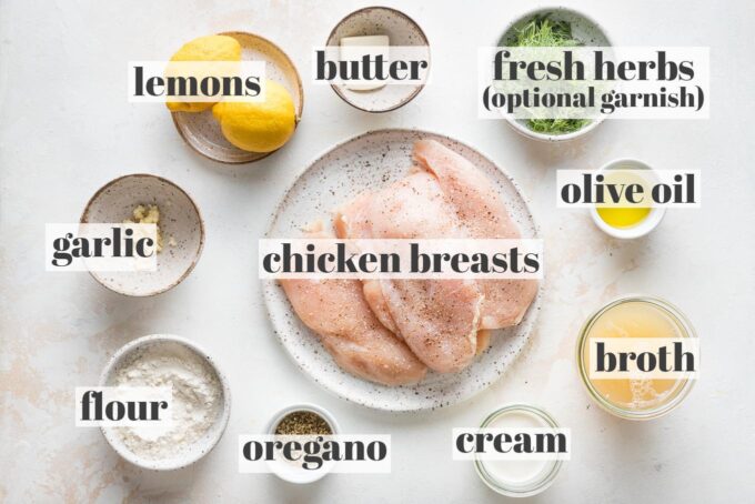 Labeled photo of chicken breasts seasoned with salt and pepper, butter, olive oil, lemons, fresh dill, chicken broth, cream, dried oregano, flour, and garlic in prep bowls.