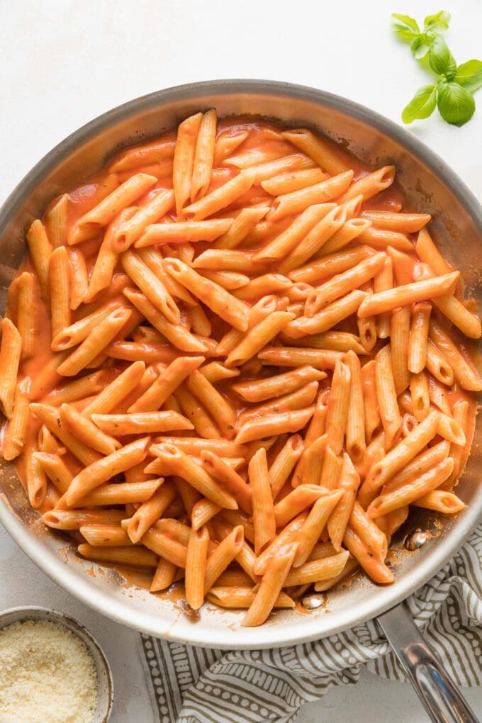 Creamy tomato pasta tossed together in a skillet.